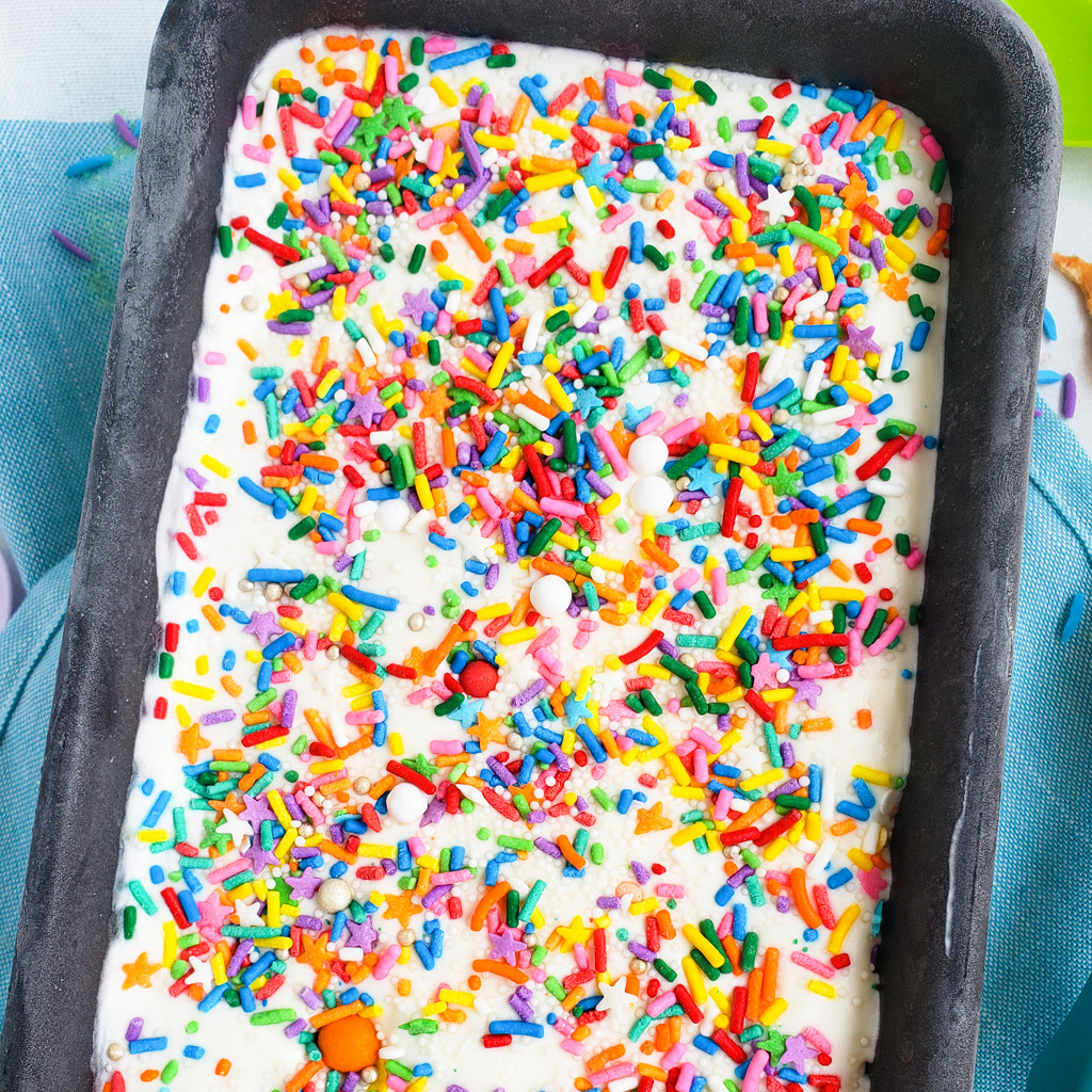 Beat the heat with this delicious, cool No Churn Confetti Ice Cream. Funfetti No Churn Ice Cream made with 3 ingredients in a loaf pan with sprinkles on top. littleeatsandthings.com 