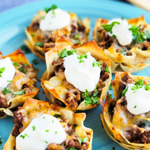 Easy Cheesy Taco Cups! Perfect for Taco Tuesday made with wontons, taco meat, sour cream. beautifuleatsandthings.com