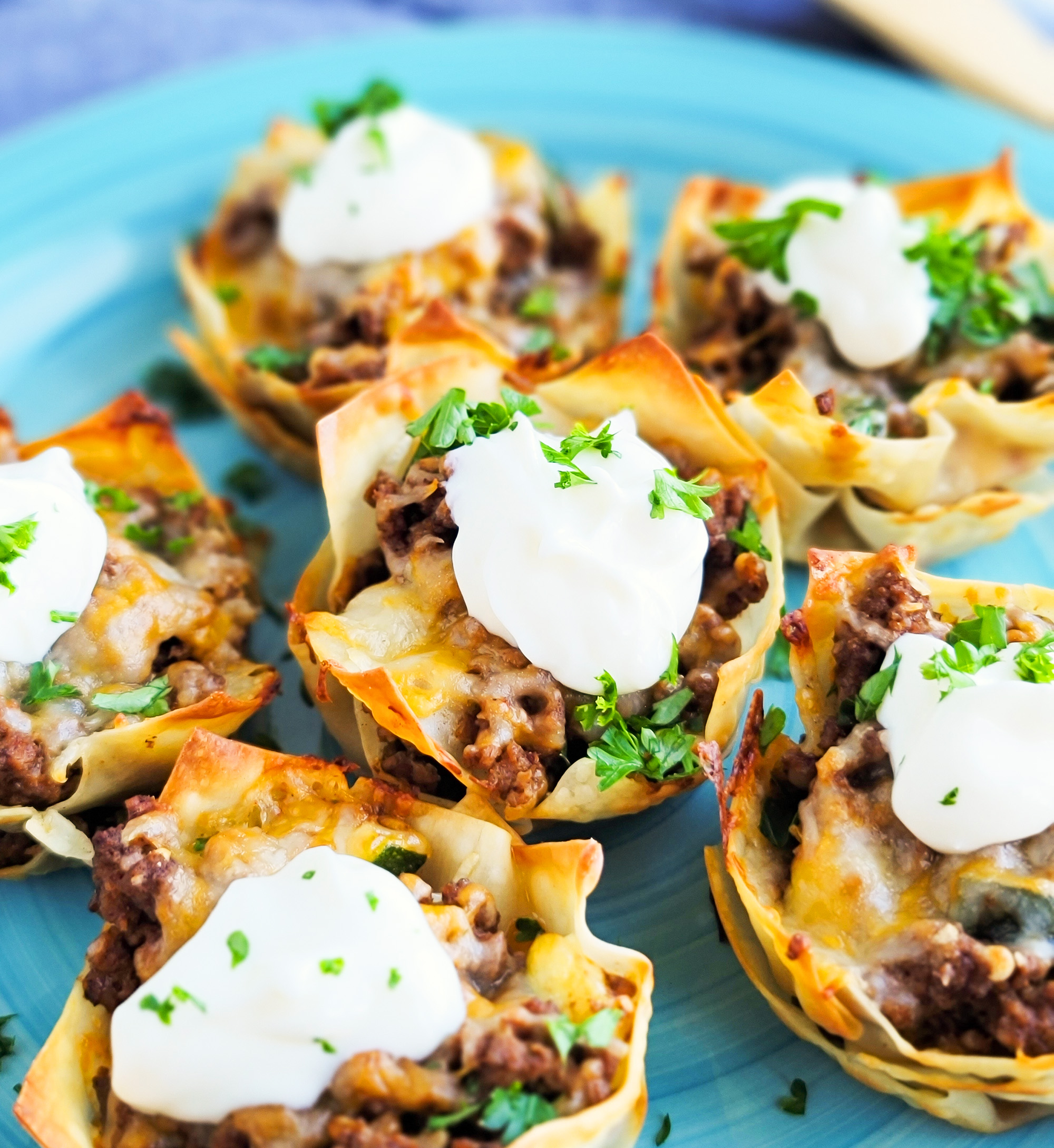 Easy Cheesy Taco Cups! Perfect for Taco Tuesday made with wontons, taco meat, sour cream.  beautifuleatsandthings.com