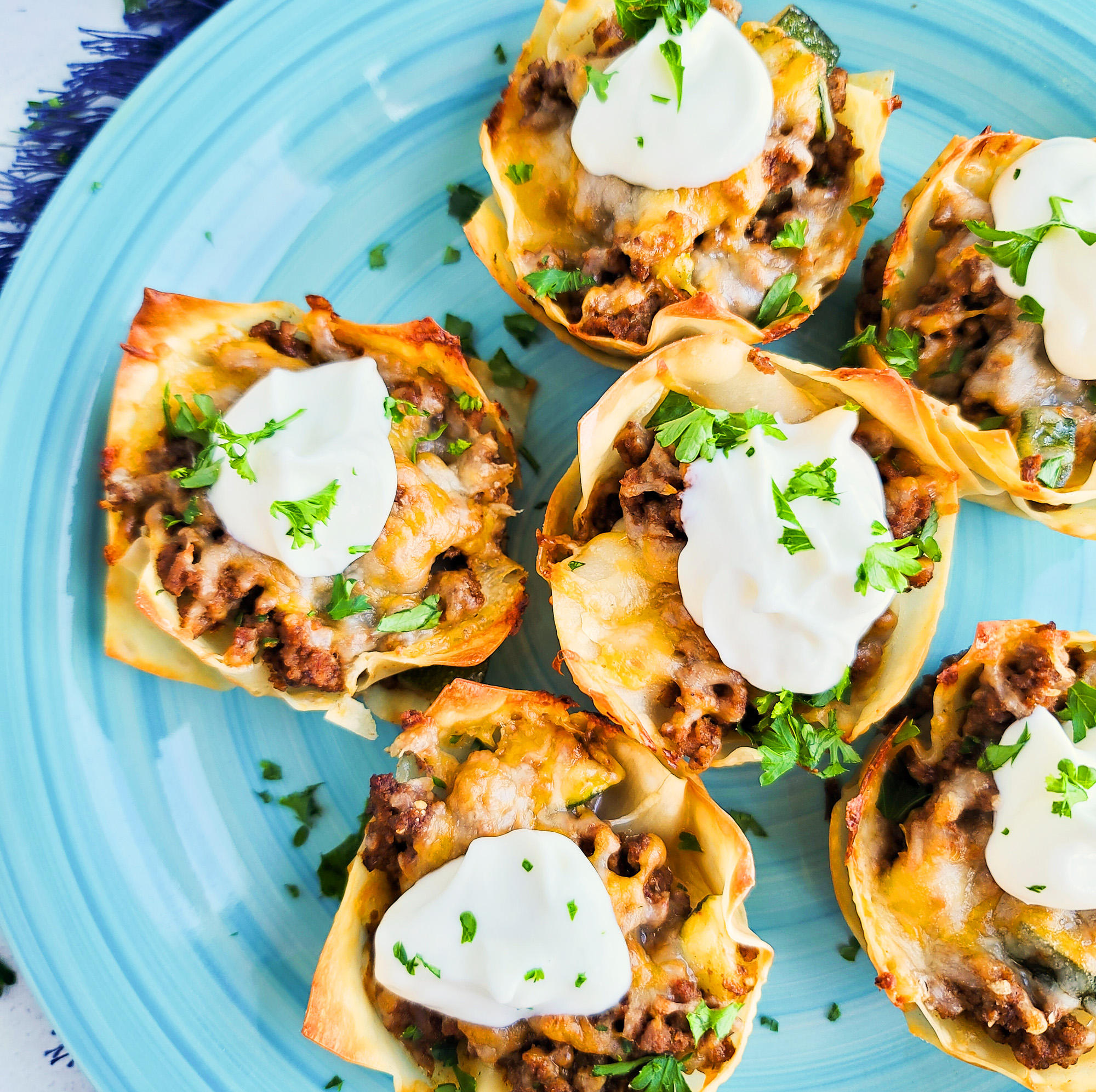 Easy Cheesy Taco Cups! Perfect for Taco Tuesday made with wontons, taco meat, sour cream.  beautifuleatsandthings.com