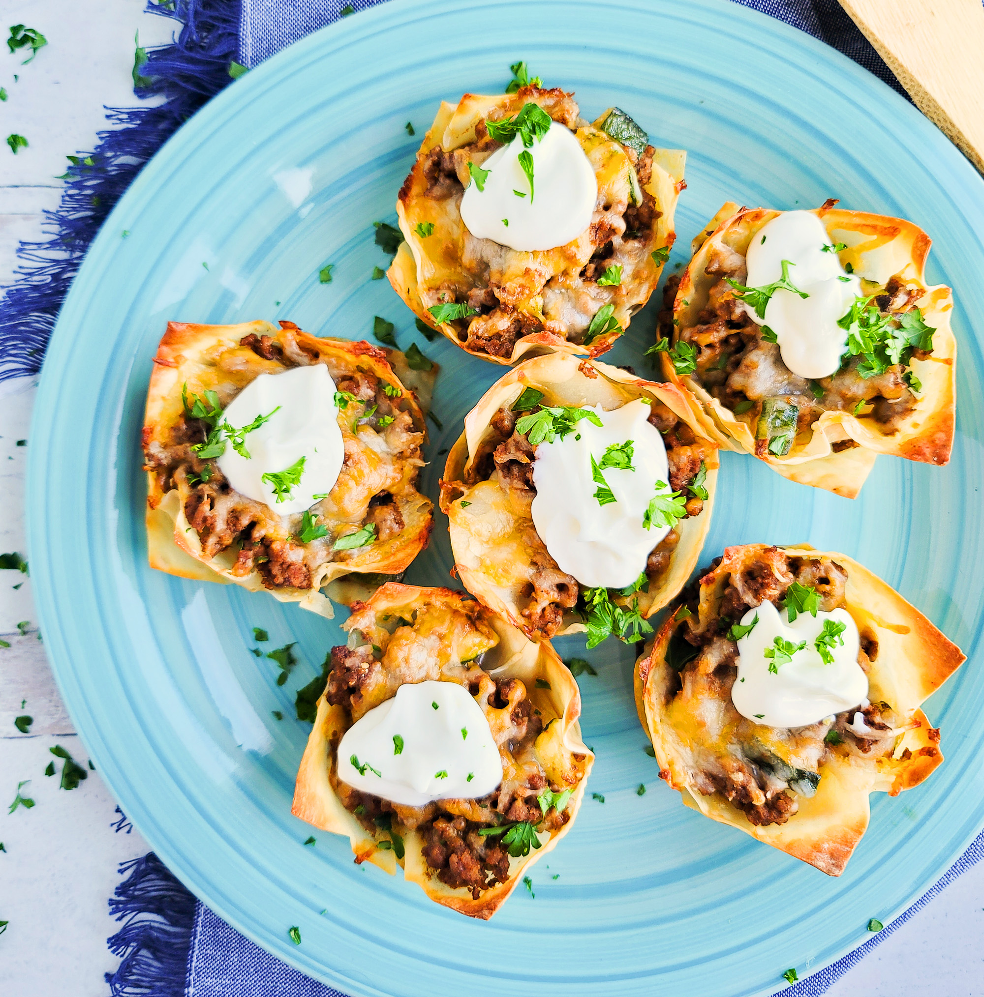 Easy Cheesy Taco Cups! Perfect for Taco Tuesday made with wontons, taco meat, sour cream.  beautifuleatsandthings.com