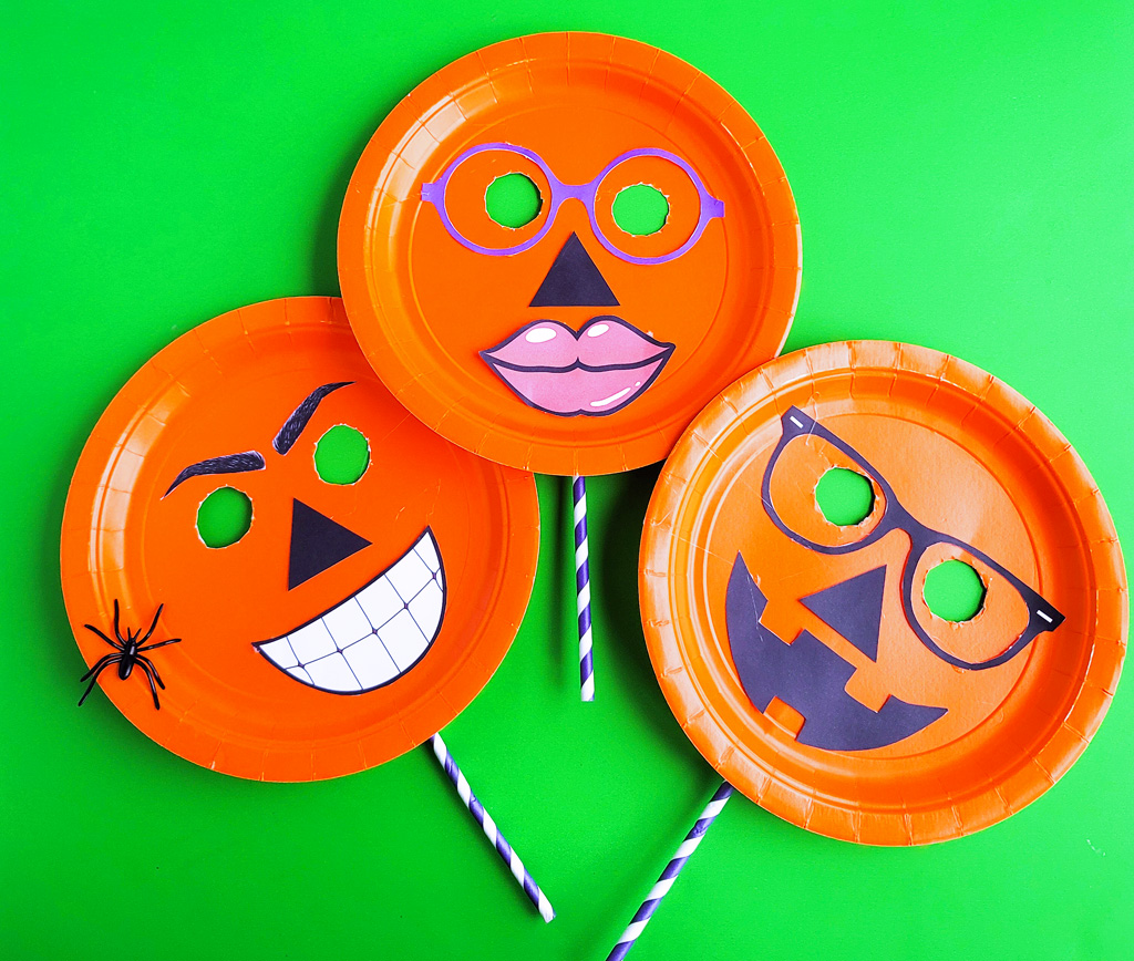 DIY Halloween Pumpkin Masks made with orange Paper Plates and cut out faces littleeatsandthings.com