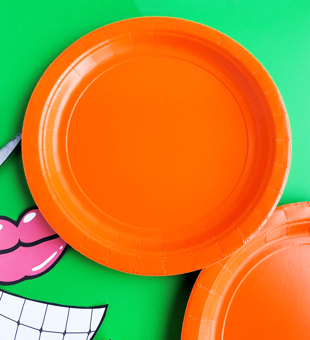 DIY Halloween Pumpkin Masks made with orange Paper Plates and cut out faces littleeatsandthings.com