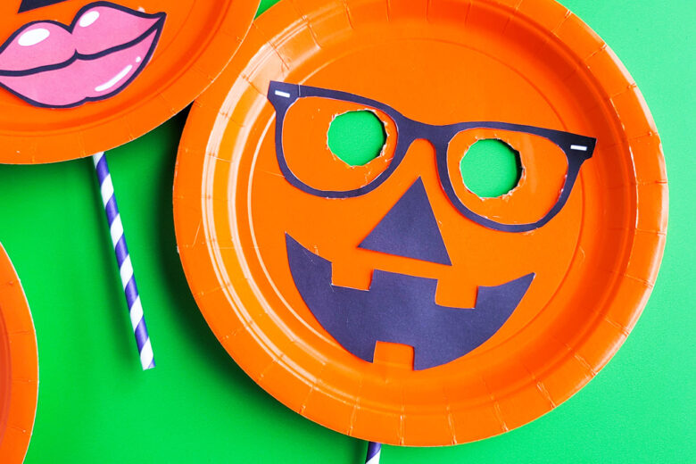 DIY Halloween Pumpkin Masks made with orange Paper Plates and cut out faces littleeatsandthings.com