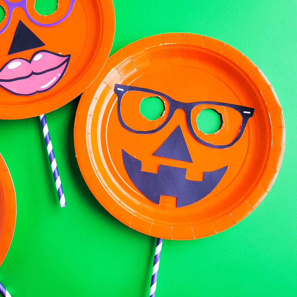 DIY Halloween Pumpkin Masks made with orange Paper Plates and cut out faces littleeatsandthings.com