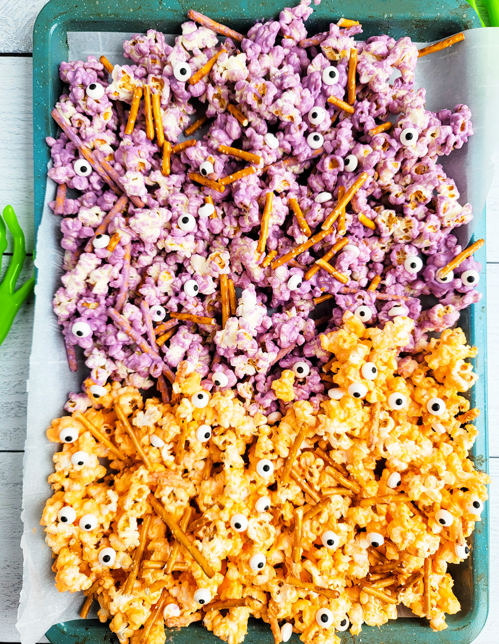 Spooky Halloween Popcorn Mix for the kids made with purple and orange white chocolate, pretzels, and candy eyeballs with black plastic spiders. beautifuleatsandthings.com