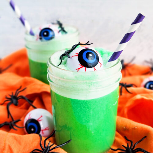 Try this Spooky Green Halloween Punch; green punch in a glass with plastic eyeballs and spiders and a purple straw littleeatsandthings.com