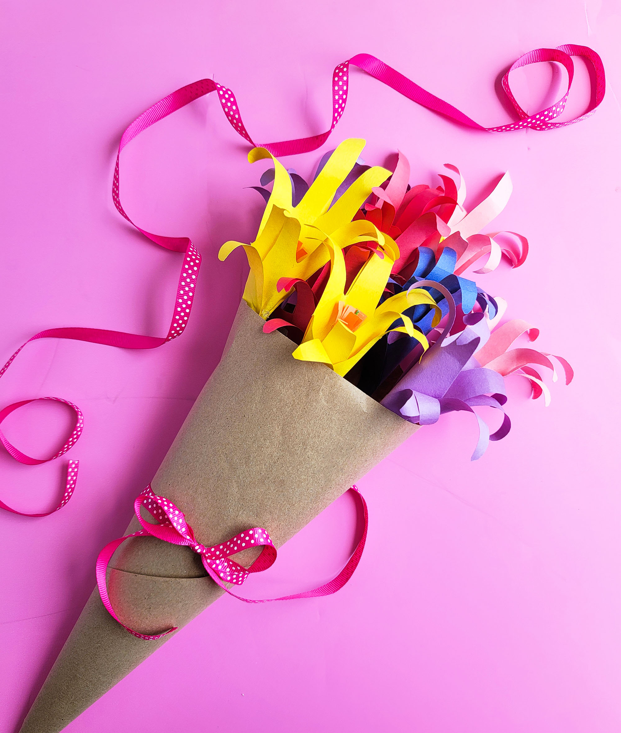 Easy DIY Handprint Flower Bouquet made from kids or students handprints on a pink surface  littleatsandthings.com