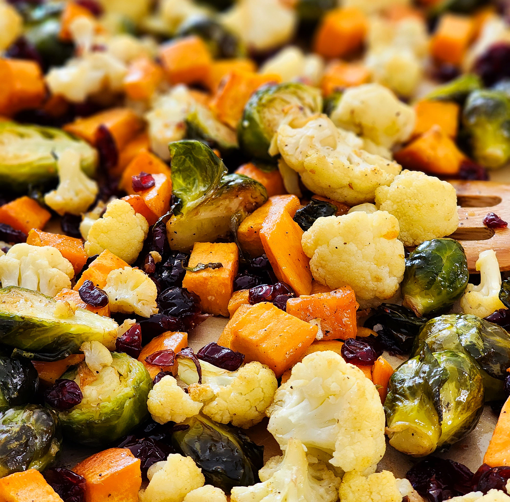 fall roasted vegetables, Brussels sprouts, sweet potatoes, cauliflower in on a baking sheet and green bowls  littleeatsandthings.com