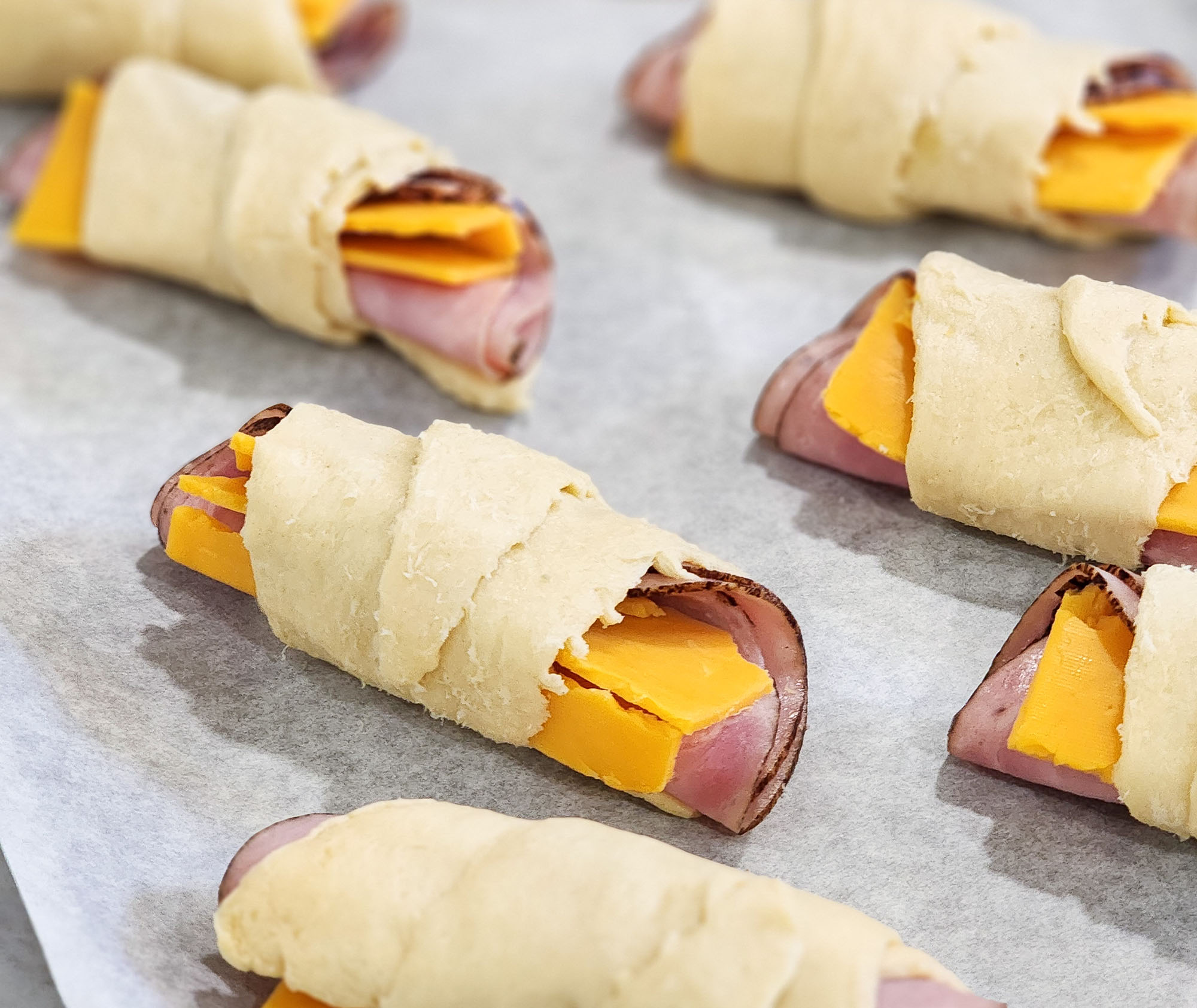 Ham & Cheese Crescent Roll Ups on a silver plate  littleeatsandthings.com