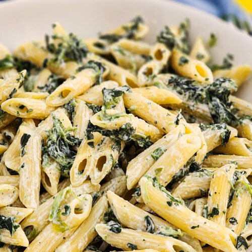 Creamed spinach noodles in a white bowl littleeatsandthings.com